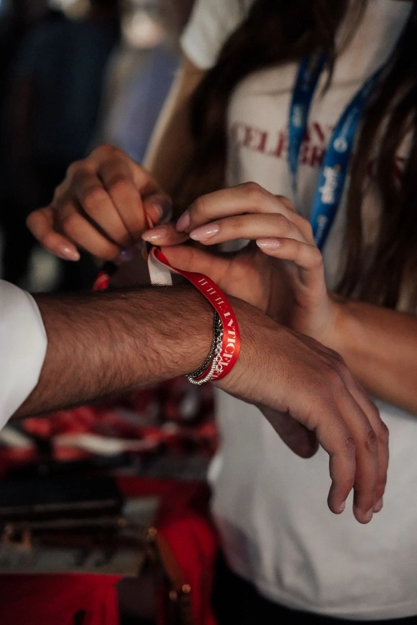 Putting on an “I’m a proud Anticelebrant” wristband